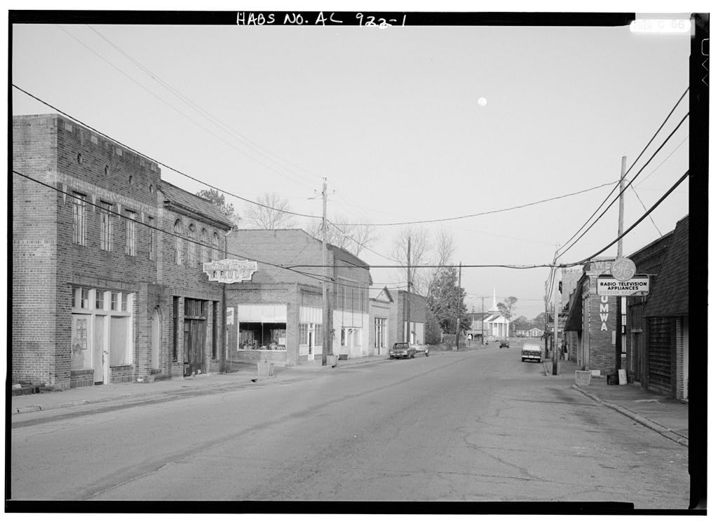 A black-and-white main street of brick storefronts in West Blocton, Alabama